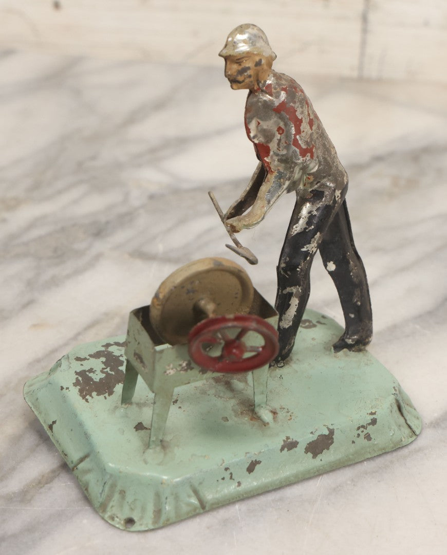Lot 049 - Antique German Tin Occupational Toy, Man Working At Grinding Wheel, Note Paint Losses, Other Wear