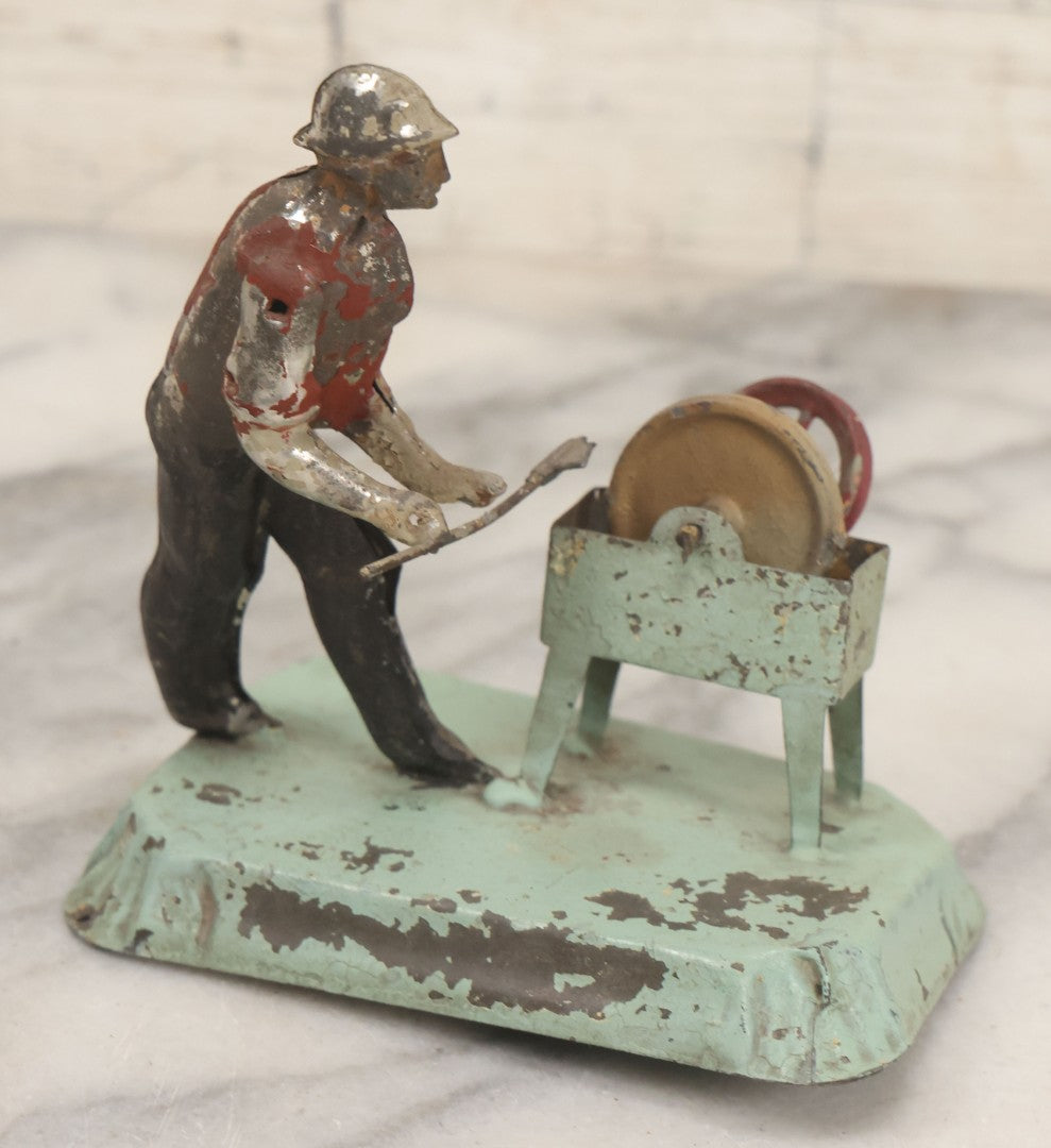 Lot 049 - Antique German Tin Occupational Toy, Man Working At Grinding Wheel, Note Paint Losses, Other Wear