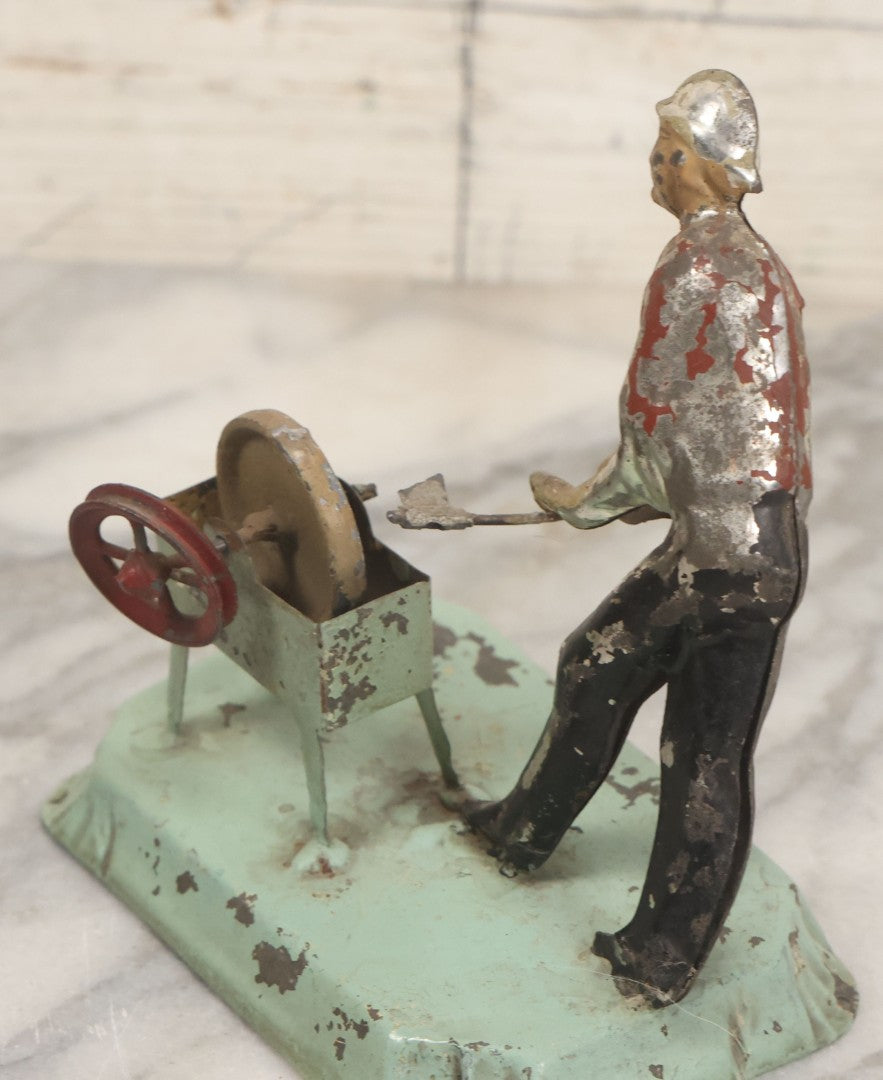 Lot 049 - Antique German Tin Occupational Toy, Man Working At Grinding Wheel, Note Paint Losses, Other Wear