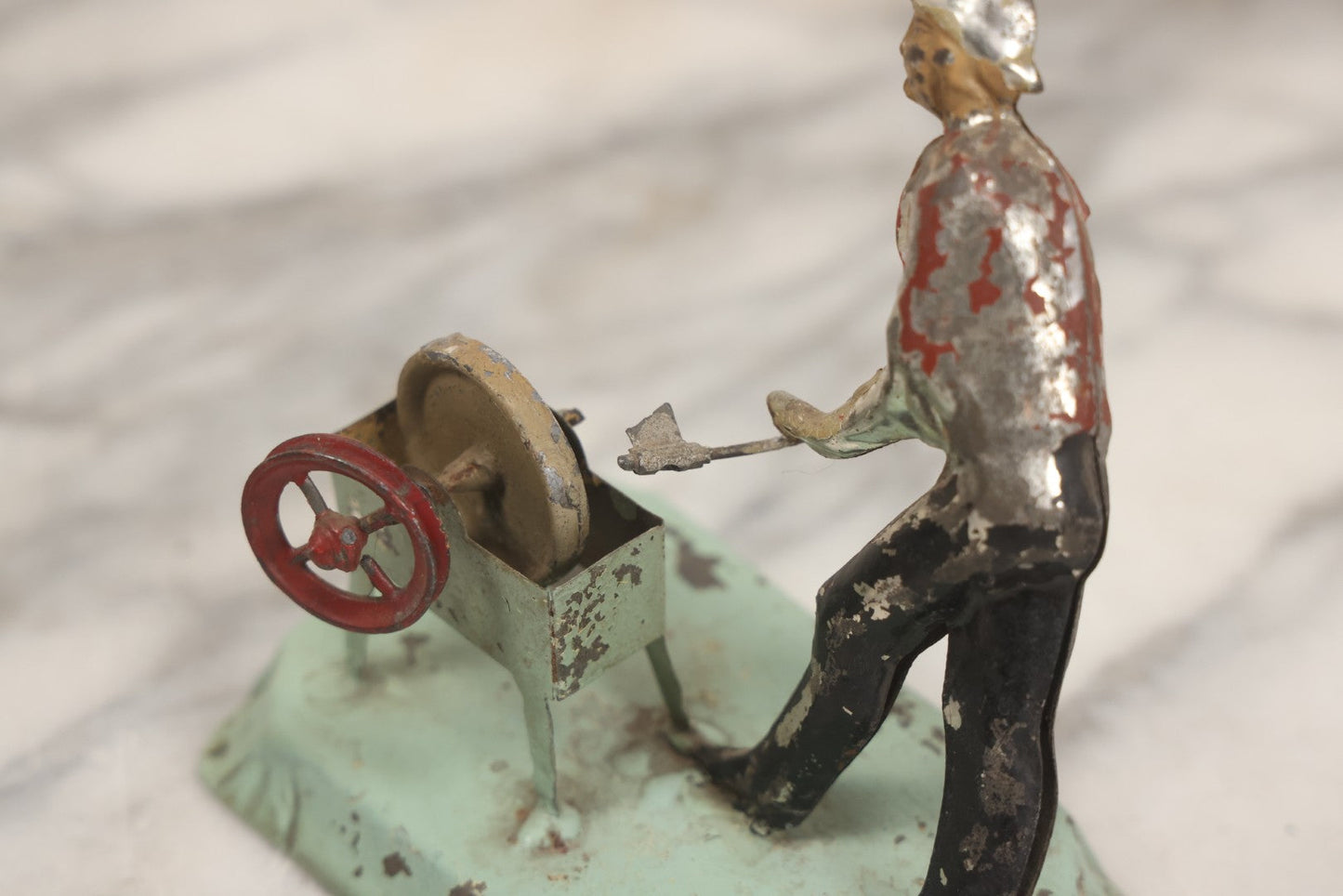 Lot 049 - Antique German Tin Occupational Toy, Man Working At Grinding Wheel, Note Paint Losses, Other Wear