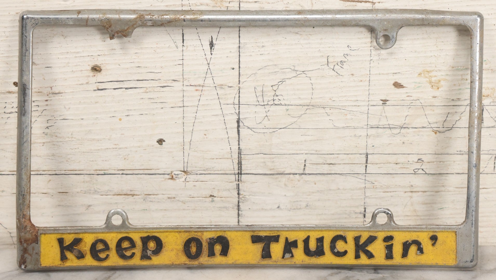Lot 055 - Vintage "Keep On Truckin'" Metal License Plate Frame Topper