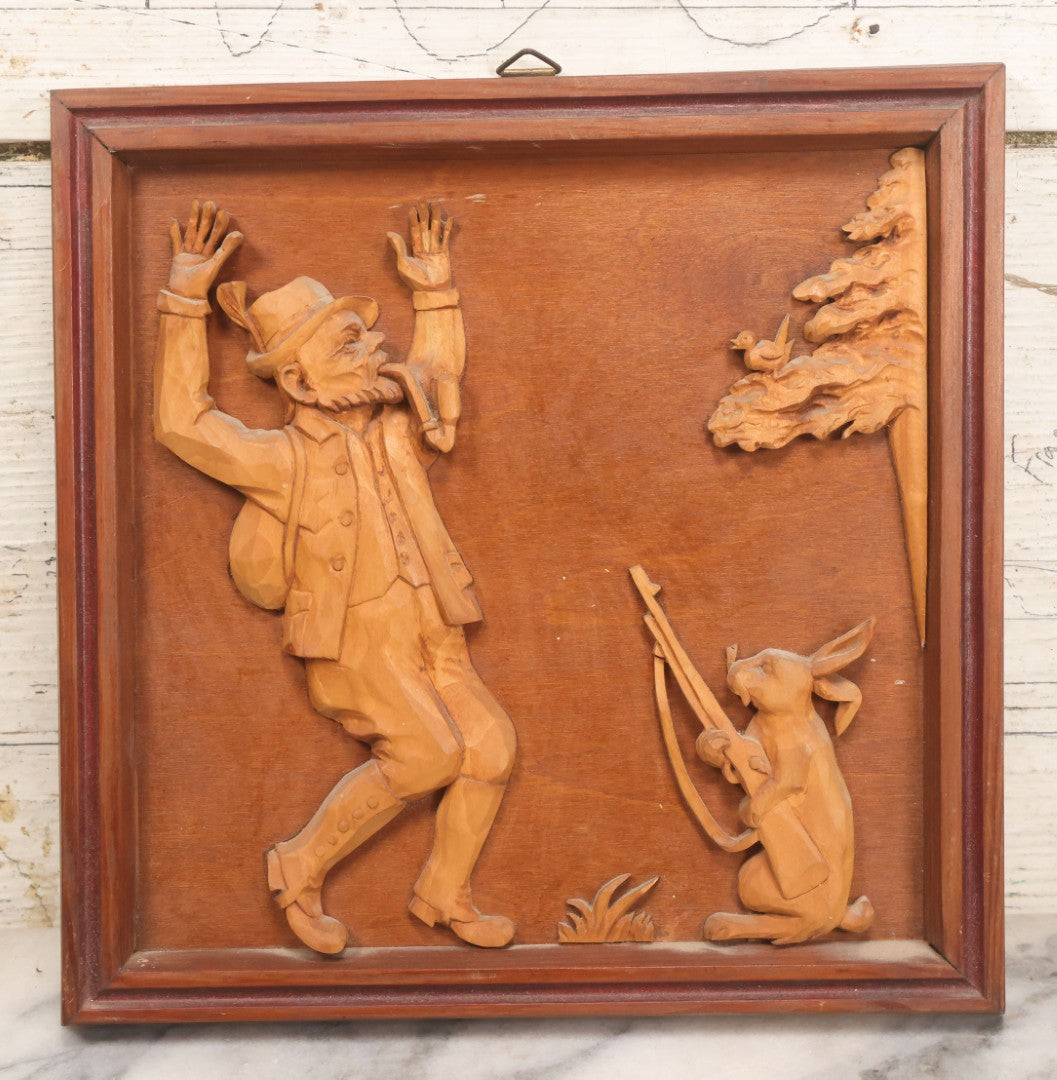 Lot 075 - Vintage Hand Carved German Folk Art Wall Hanger, Hunter Smoking Pipe Held Hostage By Rabbit With Gun