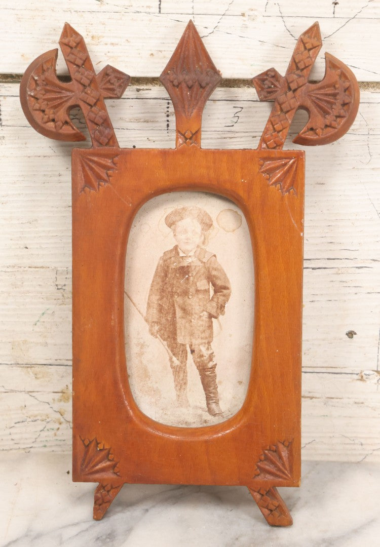 Lot 083 - Antique Folk Art Hand Carved Wooden Photo Frame With Crossed Axes, Spear Motifs, With Cabinet Card Photo Of Little Boy