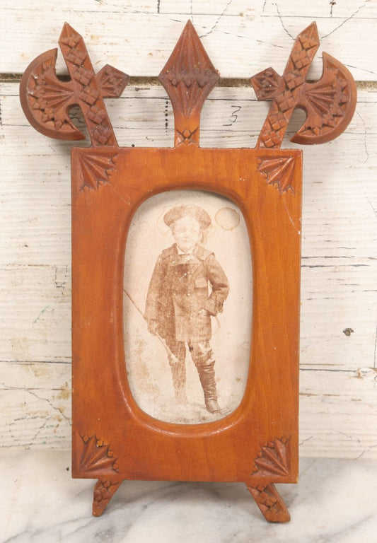 Lot 083 - Antique Folk Art Hand Carved Wooden Photo Frame With Crossed Axes, Spear Motifs, With Cabinet Card Photo Of Little Boy