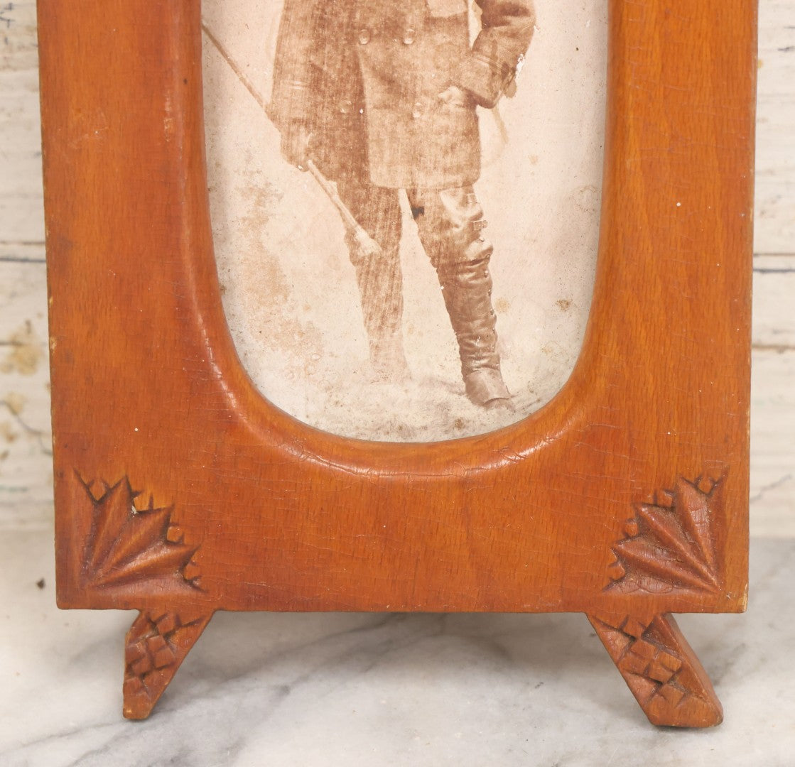 Lot 083 - Antique Folk Art Hand Carved Wooden Photo Frame With Crossed Axes, Spear Motifs, With Cabinet Card Photo Of Little Boy