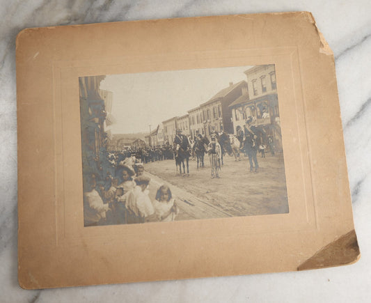 Lot 123 - Antique Boarded Photograph Of A Parade, Likely Fourth Of July, Including Man In Uncle Sam Costume Horseback Mounted Military, Onlookers, American Flags, Downtown Area, Possibly Baltimore Maryland, Verso Marked John Hopkins