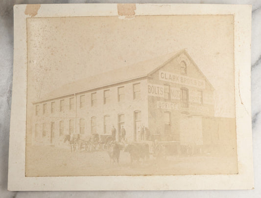 Lot 124 - Antique Boarded Occupational Photograph Of The Clarke Bros & Co. Bolts And Nuts Office And Warehouse Building With Train Car, Cattle, Horses, And Workers In Frame