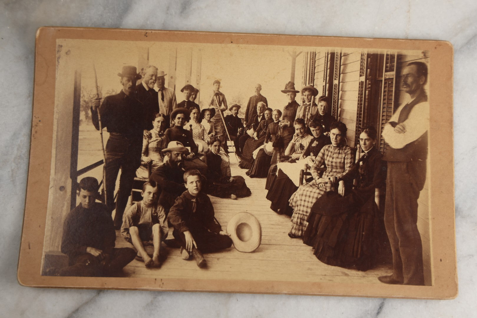 Lot 125 - Antique Boarded Photograph Of A Large Gathering On A Front Porch Of An Inn, With Identifications And Info On Verso