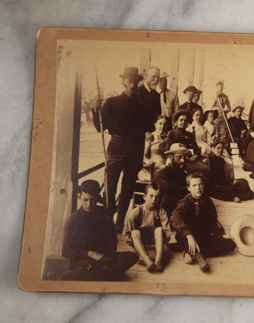 Lot 125 - Antique Boarded Photograph Of A Large Gathering On A Front Porch Of An Inn, With Identifications And Info On Verso