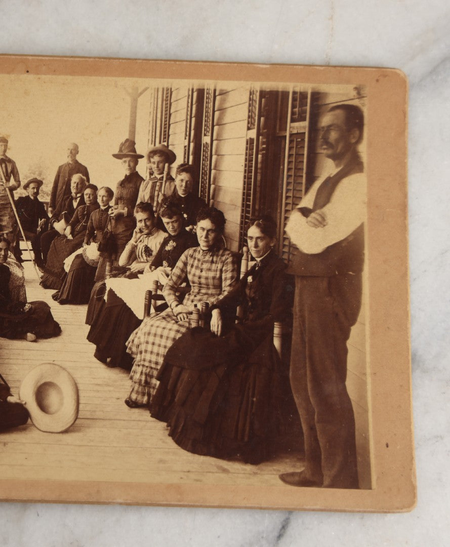 Lot 125 - Antique Boarded Photograph Of A Large Gathering On A Front Porch Of An Inn, With Identifications And Info On Verso