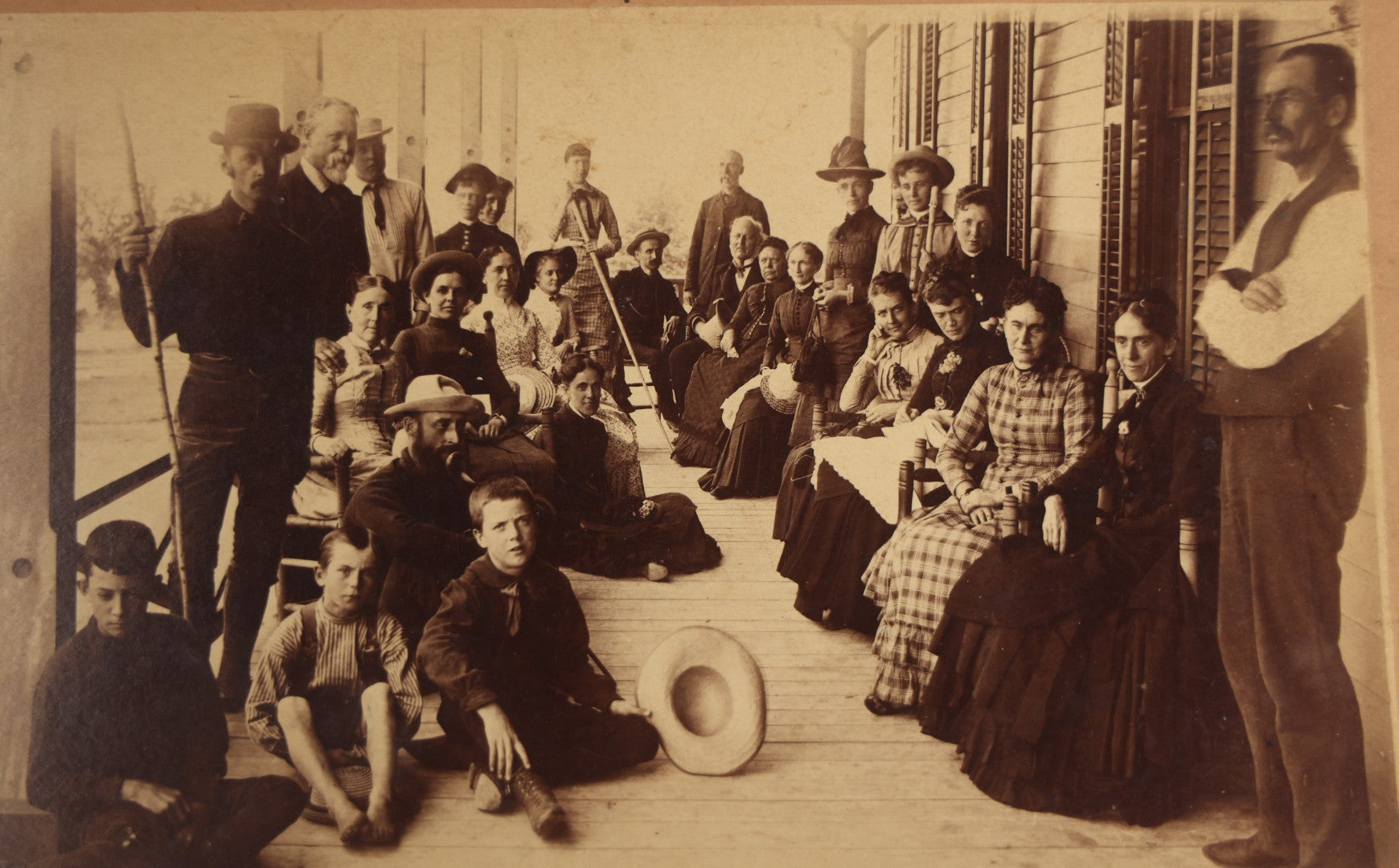 Lot 125 - Antique Boarded Photograph Of A Large Gathering On A Front Porch Of An Inn, With Identifications And Info On Verso