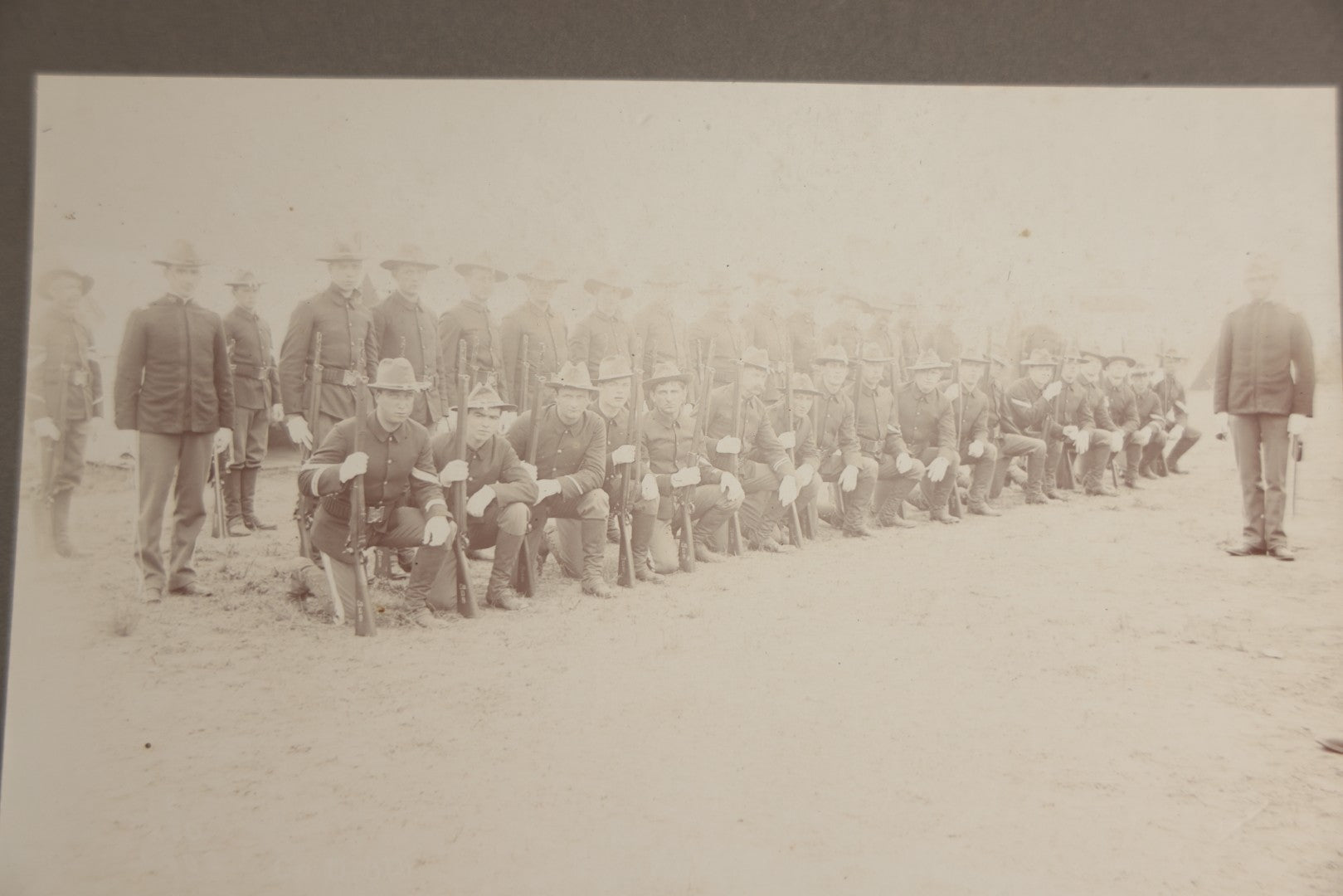 Lot 129 - Pair Of Antique Boarded Photographs Of Military Soldiers In Formation With Officer, Rifles In Frame, Circa 1890