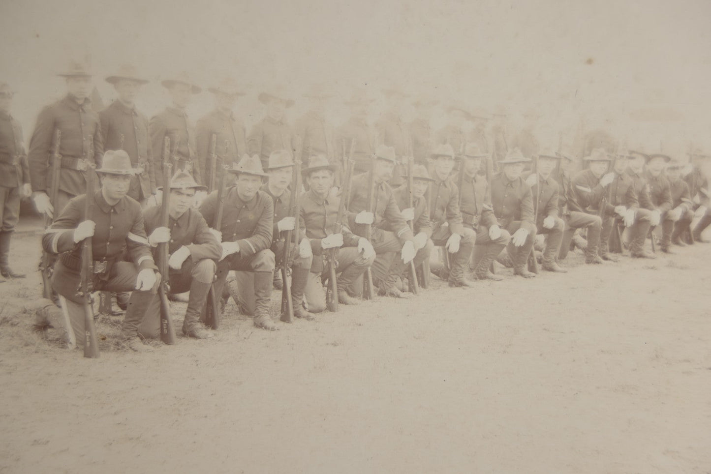 Lot 129 - Pair Of Antique Boarded Photographs Of Military Soldiers In Formation With Officer, Rifles In Frame, Circa 1890