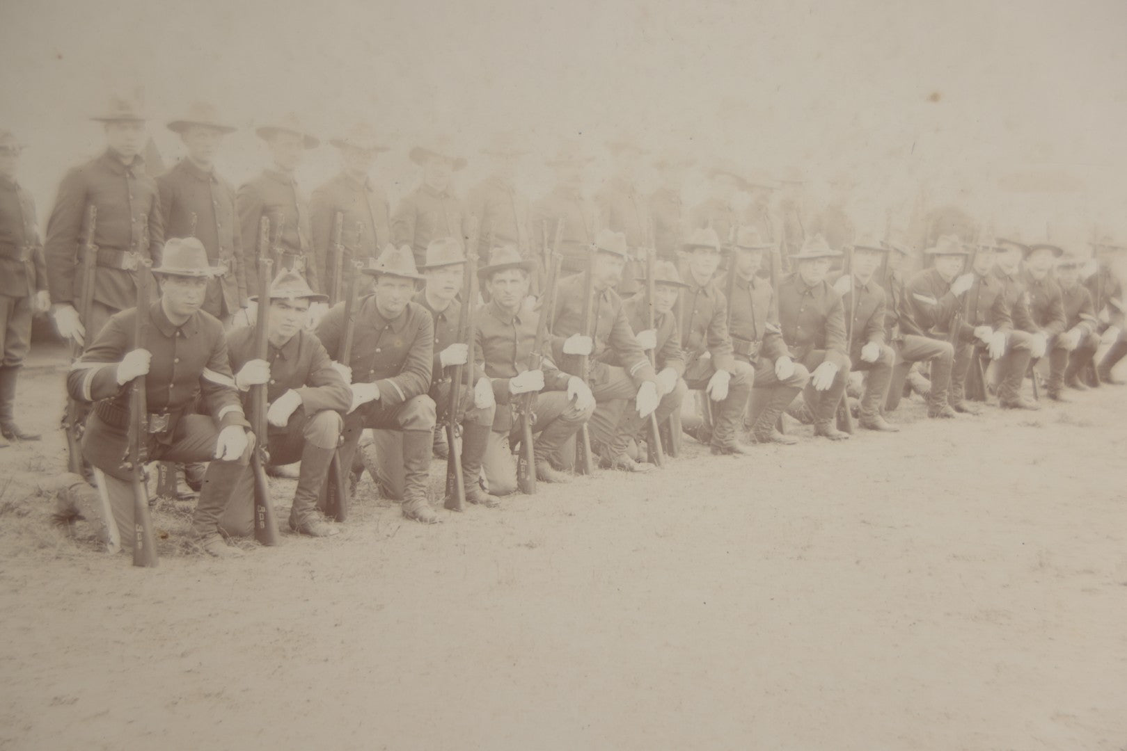 Lot 129 - Pair Of Antique Boarded Photographs Of Military Soldiers In Formation With Officer, Rifles In Frame, Circa 1890