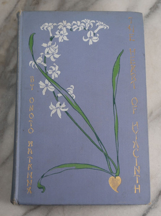 Lot 159 - "The Heart Of Hyacinth" Antique Book By Onoto Watanna, Illustrated With Decorations By Kokichi Sano, Light Blue Cloth Boards With White And Green Floral Design And Gilt Titles, Harper & Brothers, Publishers, New York And London, 1903