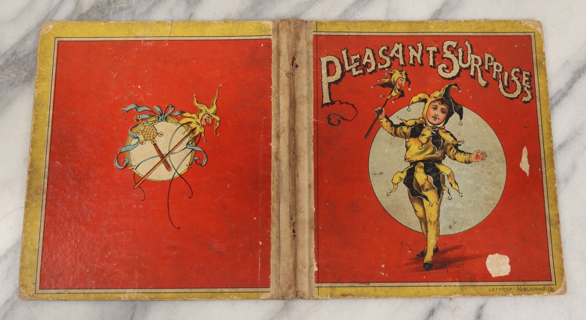 Lot 209 - Antique Children's Book Cover With Child Jester Clown, "Pleasant Surprises," Lothrop Publishing Co., Note No Contents, Book Cover Only, As Found