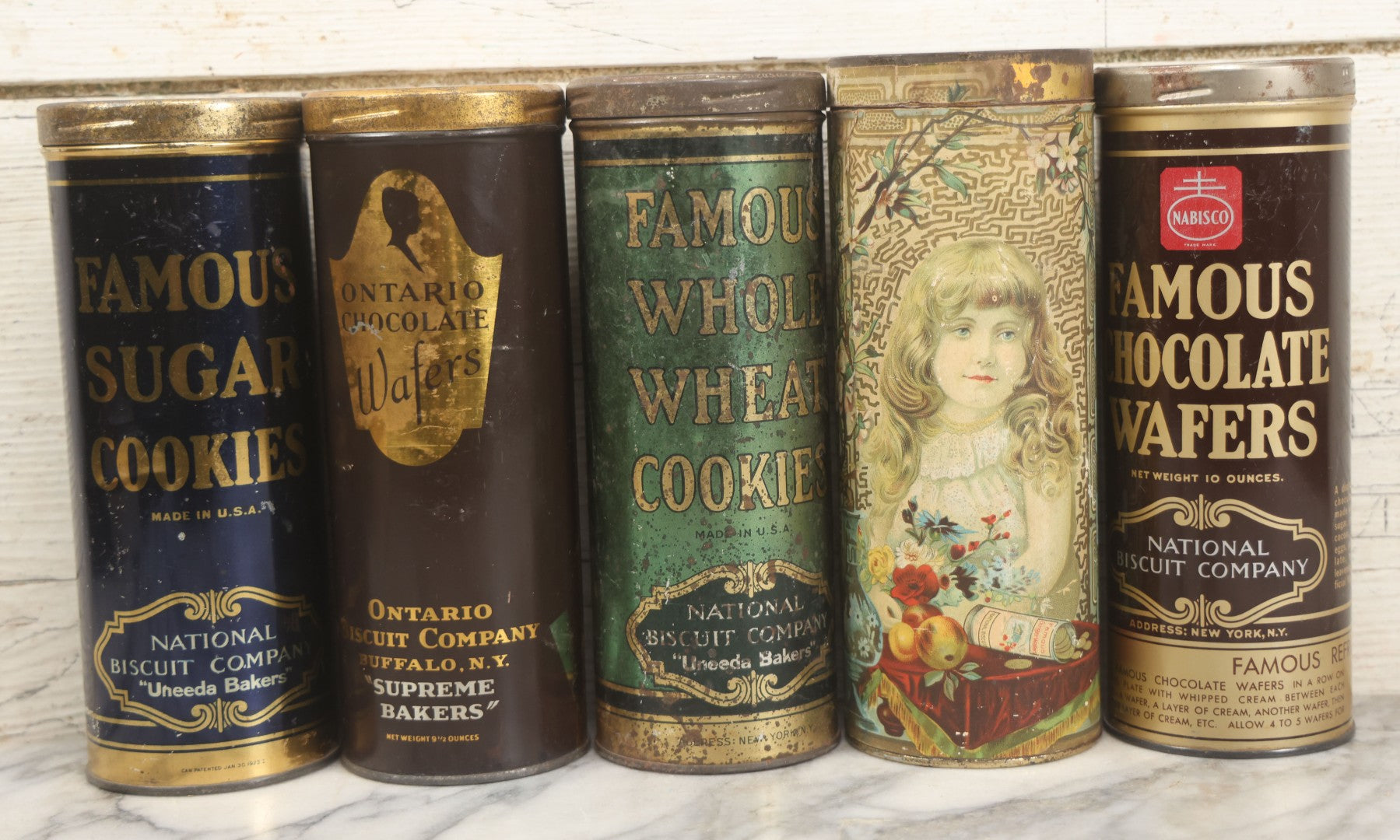 Lot 227 - Grouping Of Five Vintage Cookie And Wafer Tube Advertising Tins Including Famous Sugar Cookies, Ontario Chocolate Wafers, Famous Whole Wheat Cookies, Famous Ginger Wafers, And Famous Chocolate Wafers, National Biscuit Company