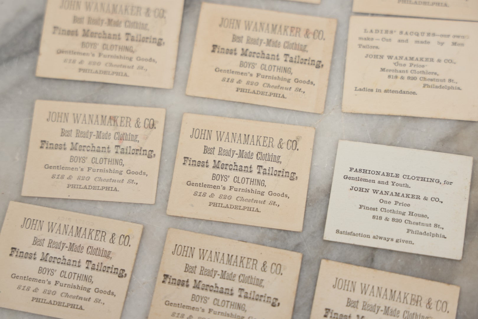 Lot 254 - Grouping Of Twenty Antique Lithgraphed Trade Card Advertisements Showing The Flags Of The World, Advertising John Wanamaker & Co., Clothing, Philadelphia, Pennsylvania 