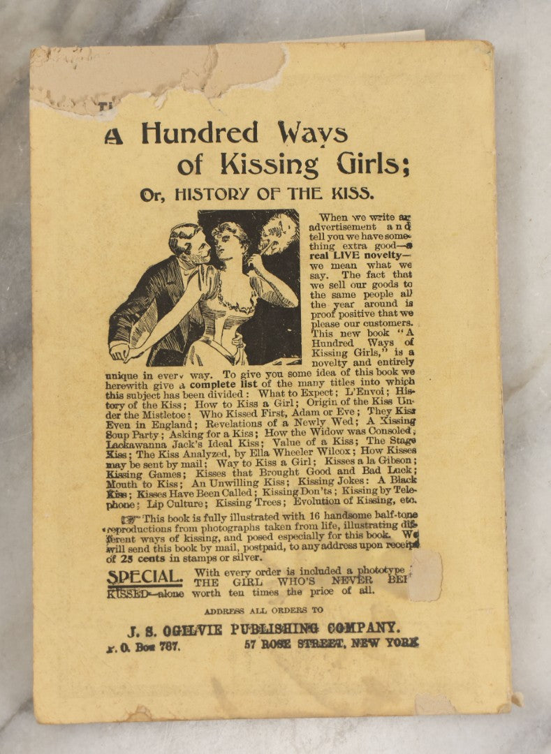 Lot 266 - "Love, Courtship, Marriage By A Woman Of The World" Antique Illustrated Paperback With Cupid Illustration On Cover And Bandaged Cat Mascot, J.S. Ogilvie, Publisher, New York, 1902, "A Hundred Ways Of Kissing Girls" Advertisement On Back Cover
