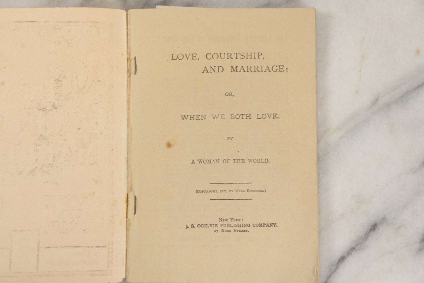 Lot 266 - "Love, Courtship, Marriage By A Woman Of The World" Antique Illustrated Paperback With Cupid Illustration On Cover And Bandaged Cat Mascot, J.S. Ogilvie, Publisher, New York, 1902, "A Hundred Ways Of Kissing Girls" Advertisement On Back Cover