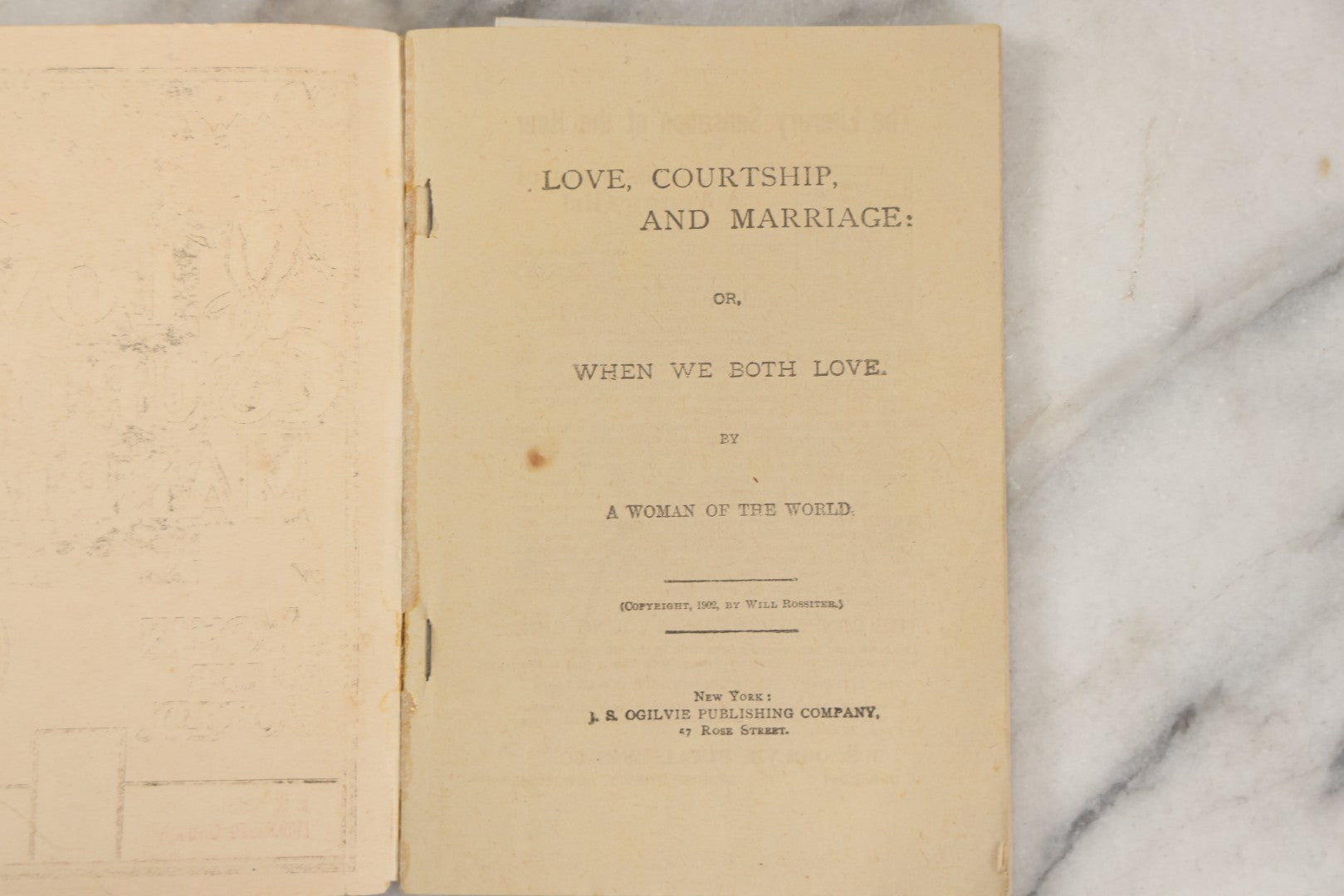Lot 266 - "Love, Courtship, Marriage By A Woman Of The World" Antique Illustrated Paperback With Cupid Illustration On Cover And Bandaged Cat Mascot, J.S. Ogilvie, Publisher, New York, 1902, "A Hundred Ways Of Kissing Girls" Advertisement On Back Cover