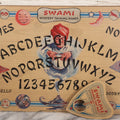 Lot 002 - Vintage Swami Mystery Talking Board Ouija Board Spirit Board With Original Planchette And Remnants Of Original Paper Sleeve, With Instruction Sheet Taped To Verso, Manufactured By Gift Craft, 666 Lake Shore Drive, Chicago, Illinois