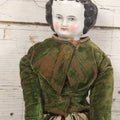 Lot 011 - Antique Victorian China Head Doll With Custom Outfit Including Velvet Blazer, Green, Pink, Yellow, And Black Striped Skirt, Knit Underskirt, White And Pink Pantyhose, And Black Stockings, 20" H