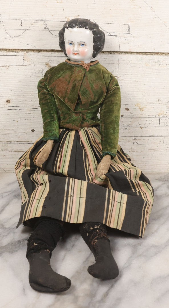 Lot 011 - Antique Victorian China Head Doll With Custom Outfit Including Velvet Blazer, Green, Pink, Yellow, And Black Striped Skirt, Knit Underskirt, White And Pink Pantyhose, And Black Stockings, 20" H