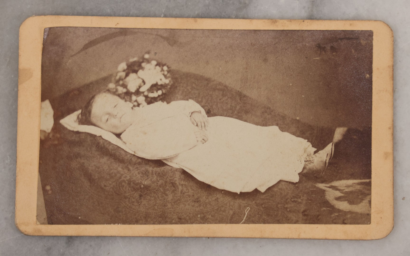 Lot 025 - Antique Post Mortem Carte De Visite C.D.V. Photograph Of A Deceased Toddler Lying At Rest, With Flower Beside Head, Photographed at G.A. Johnson's Art Gallery, St. Petersburg, Florida