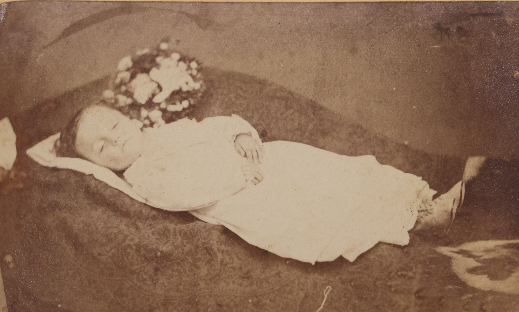 Lot 025 - Antique Post Mortem Carte De Visite C.D.V. Photograph Of A Deceased Toddler Lying At Rest, With Flower Beside Head, Photographed at G.A. Johnson's Art Gallery, St. Petersburg, Florida