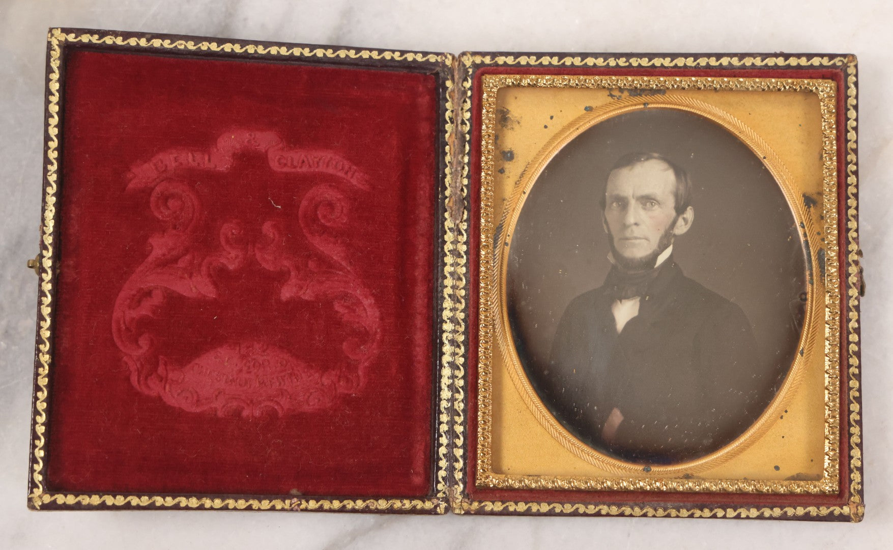 Lot 028 - Antique 1/6th Plate Daguerreotype Photograph Of A Middle Aged Man With A Chin Strap Beard, Photographed By Bell & Clayton, Philadelphia, Marked On Case Pillow, In Full Intact Leatherette Union Case, Circa 1855