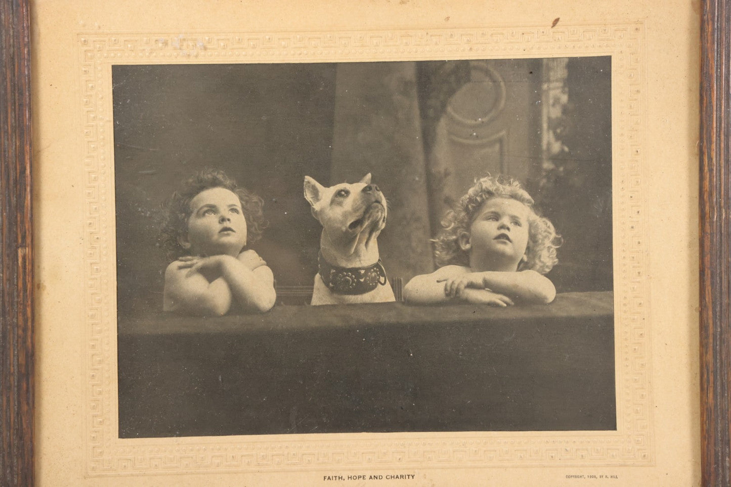 Lot 034 - Antique Comic Collectible Photo, Allegorical Three Theological Virtues, "Faith, Hope, And Charity" Depicted By Two Children And Their Dog, Copyright 1909 By R. Hill, In Frame, 12-1/8" x 10-1/8"