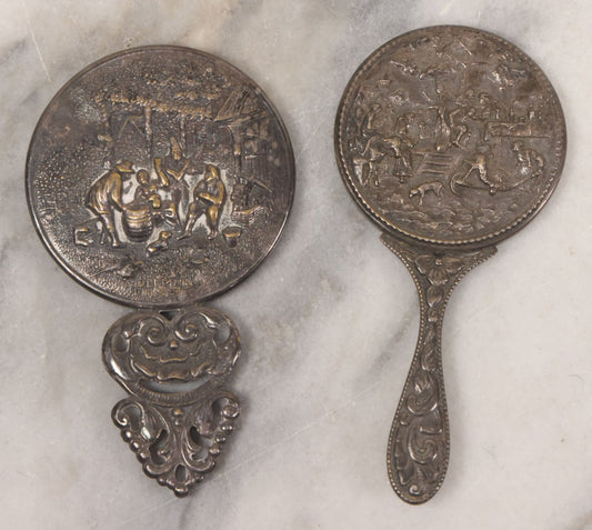 Lot 037 - Pair Of Vintage Embossed Pressed Metal Beveled Glass Hand Mirrors, Tavern & Festive Village Scenes, One Marked Denmark