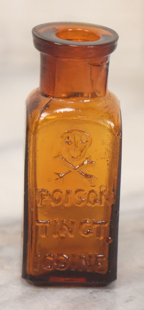 Lot 044 - Grouping Of Three Vintage Amber Glass Poison Bottles Including Tincture Of Iodine Bottle With Skull And Crossbones, Others With Embossed "Poison" Lettering, 2" and 3-5/8" Heights