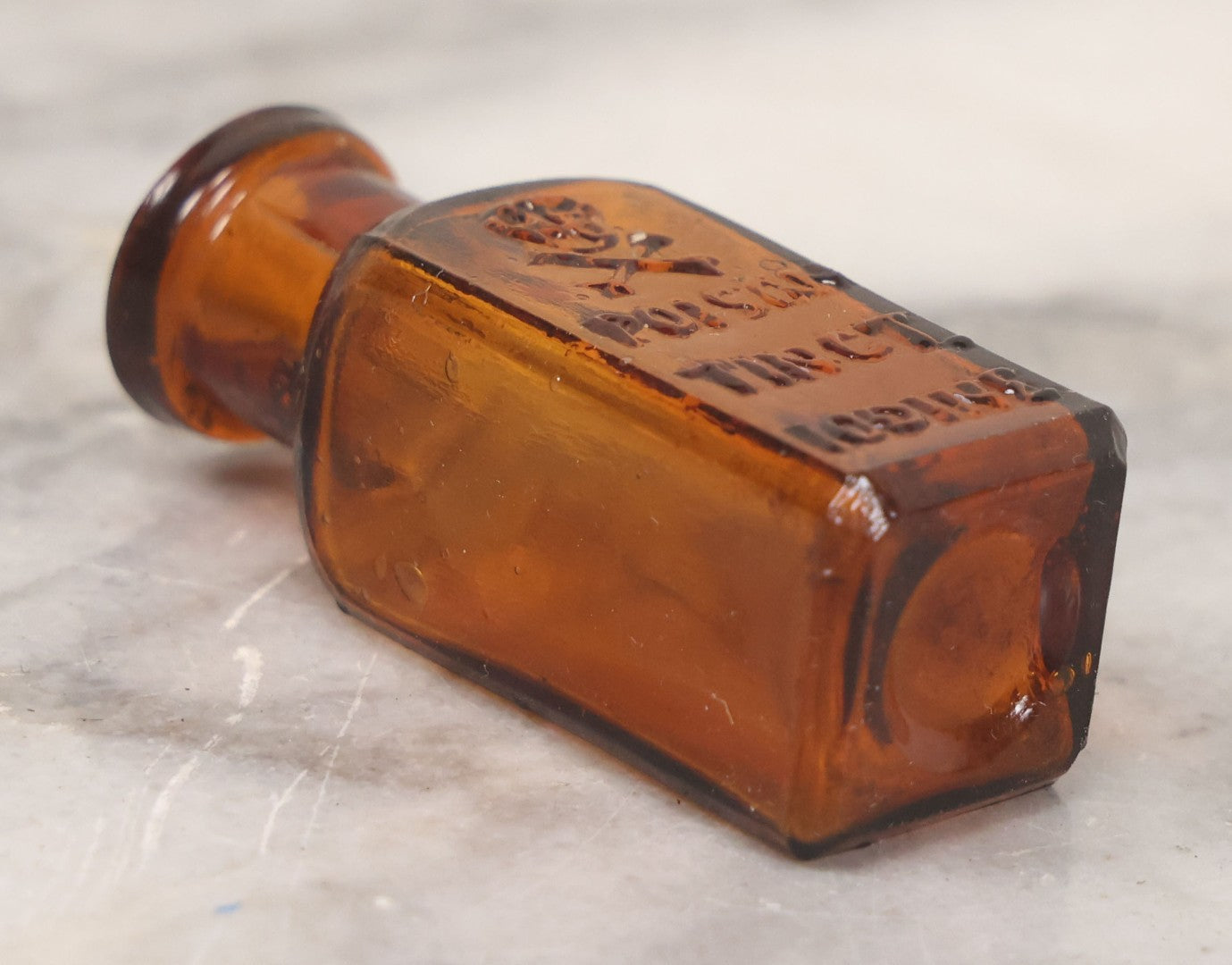 Lot 044 - Grouping Of Three Vintage Amber Glass Poison Bottles Including Tincture Of Iodine Bottle With Skull And Crossbones, Others With Embossed "Poison" Lettering, 2" and 3-5/8" Heights