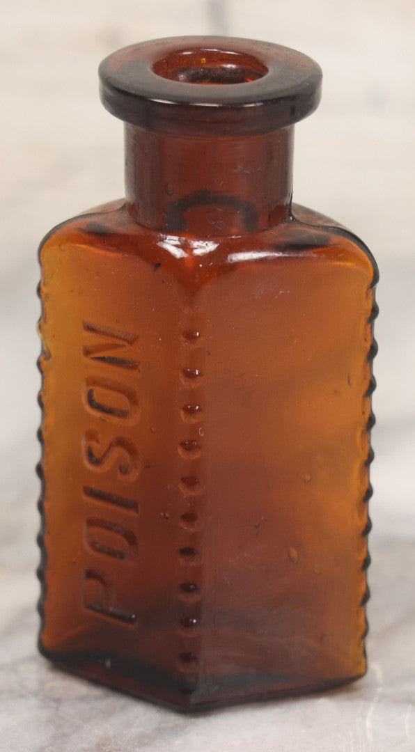 Lot 044 - Grouping Of Three Vintage Amber Glass Poison Bottles Including Tincture Of Iodine Bottle With Skull And Crossbones, Others With Embossed "Poison" Lettering, 2" and 3-5/8" Heights