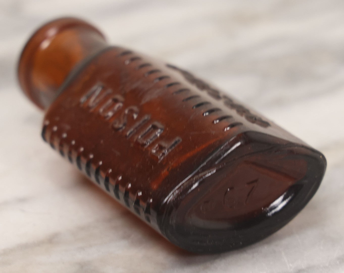 Lot 044 - Grouping Of Three Vintage Amber Glass Poison Bottles Including Tincture Of Iodine Bottle With Skull And Crossbones, Others With Embossed "Poison" Lettering, 2" and 3-5/8" Heights