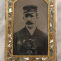 Lot 068 - Antique Tintype Photograph Of Man With Mustache Wearing Cap, In Period Reverse Painted Abalone And Gold Flake Beveled Glass Frame, 2-5/8" x 4-3/8"