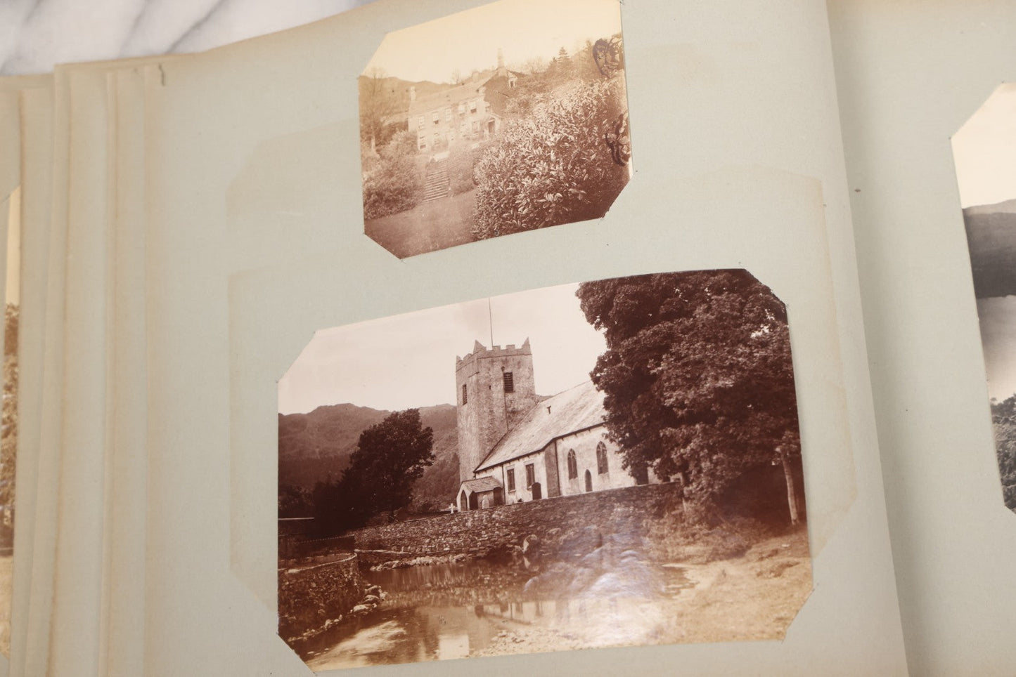 Lot 070 - Antique Photo Album With Approximately 80 Souvenir Photographs Of Landmarks Around Europe, England Including Churches And Cathedrals, Bridges, Architecture, Interiors, And Graveyards, Contained In "The Photo-Bind" Trademarked Album By J.H.H.M.