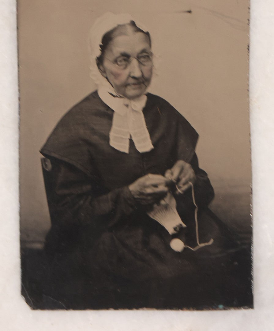 Lot 088 - Pair Of Antique Tintype Photographs Of Women Engaged In Knitting, Sewing Activities, Including Elderly Woman In Bonnet And Tintype In Brass Mat From French & Sawyer's Daguerreian Gallery, Keene, New Hampshire