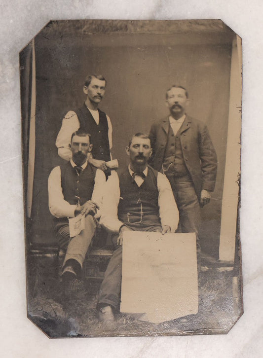 Lot 090 - Antique Tintype Photograph Of Four Well Dressed Men With Mustaches, One Man Holding Illegible Poster, Other Man Holding Pamphlet Or Book