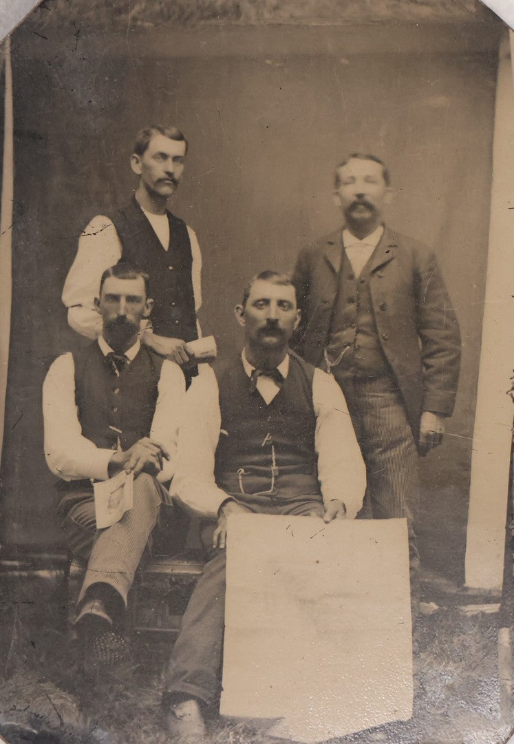 Lot 090 - Antique Tintype Photograph Of Four Well Dressed Men With Mustaches, One Man Holding Illegible Poster, Other Man Holding Pamphlet Or Book
