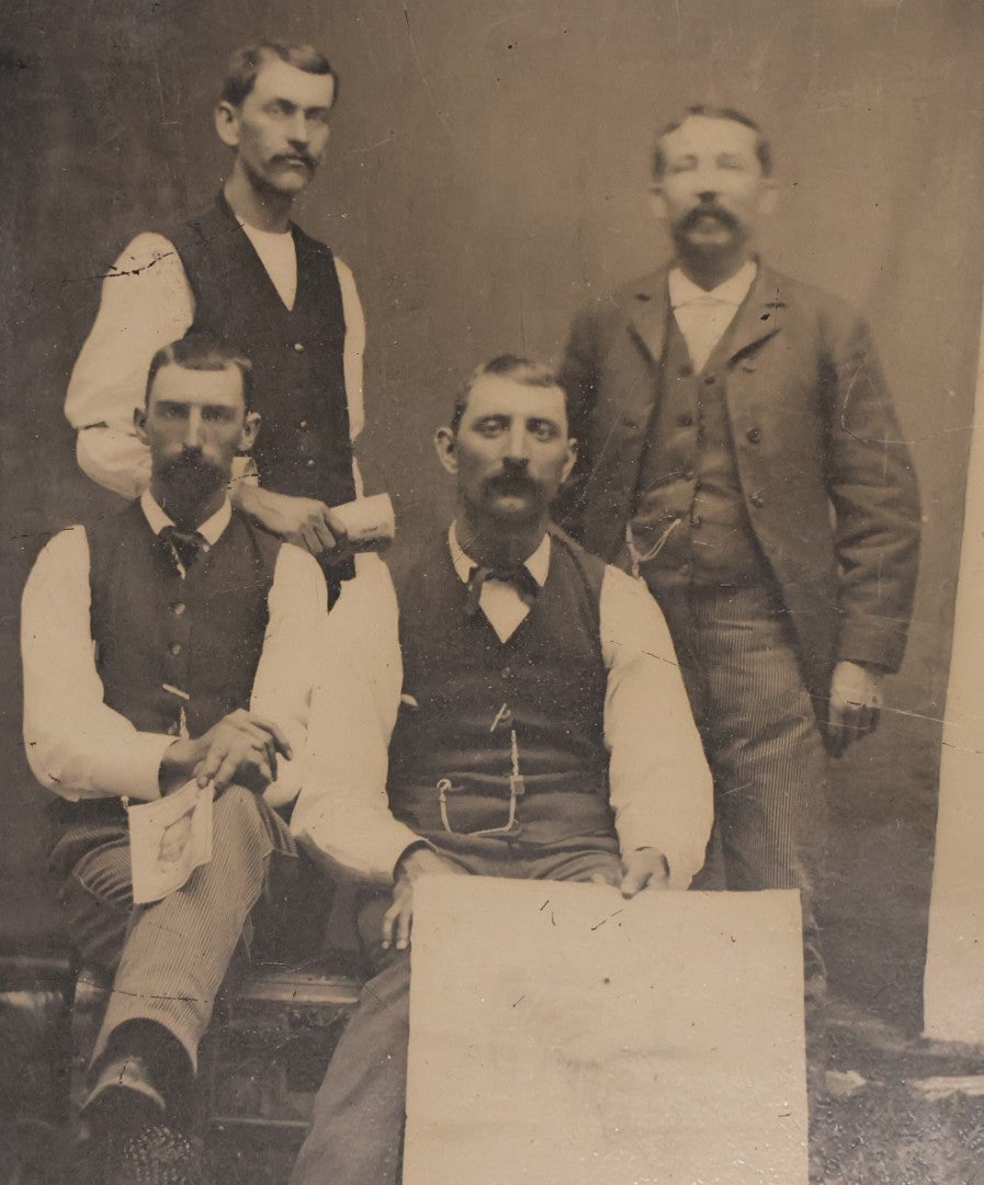 Lot 090 - Antique Tintype Photograph Of Four Well Dressed Men With Mustaches, One Man Holding Illegible Poster, Other Man Holding Pamphlet Or Book