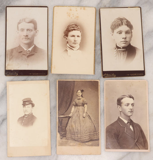 Lot 109 - Grouping Of Six Carte De Visite C.D.V. Portrait Photographs Of Men And Women, Including Man In Suit With Bowtie, Woman In Full Length Dress With Large Skirt, And Man In Officers Uniform With Slouchy Cap