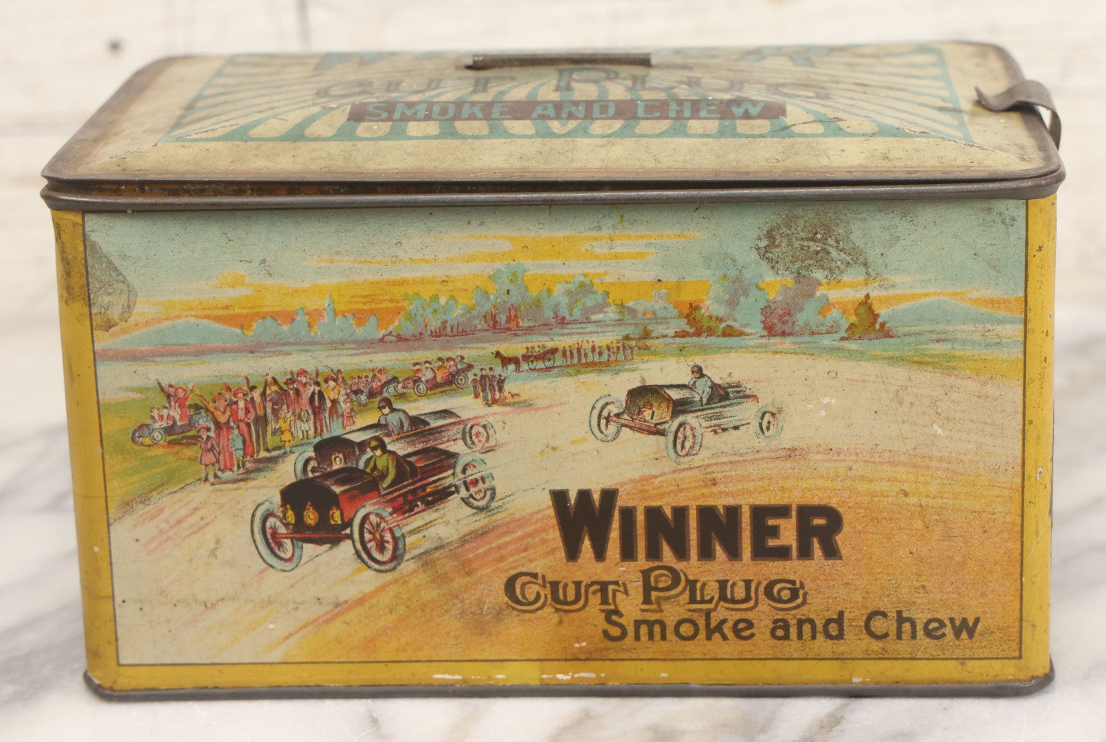 Lot 002 - Antique Tin Lithograph "Winner Cut Plug Smoke And Chew" Tobacco Tin With Auto Racing Motif, J. Wright Co., Richmond, Virginia, Circa 1910-1920, Note Missing Handle