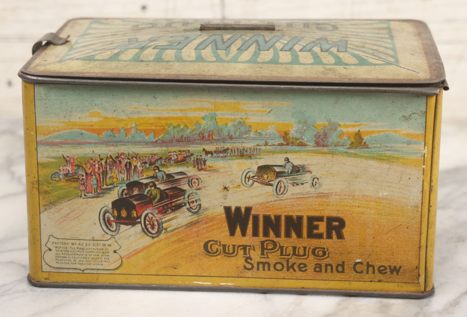 Lot 002 - Antique Tin Lithograph "Winner Cut Plug Smoke And Chew" Tobacco Tin With Auto Racing Motif, J. Wright Co., Richmond, Virginia, Circa 1910-1920, Note Missing Handle