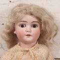 Lot 022 - Antique German Bisque Head Doll By Adolf Wislizenus, Marked "A.W. Special," Made In Germany, With Composition Body, Blonde Wig, And Clothing, Circa 1900, 24" Height