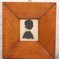 Lot 046 - Antique Folk Art Hand Cut Fabric Silhouette Of Young Girl With Added Pencil Details In Wide Tiger Maple Frame, 6-7/8" x 7-3/8"