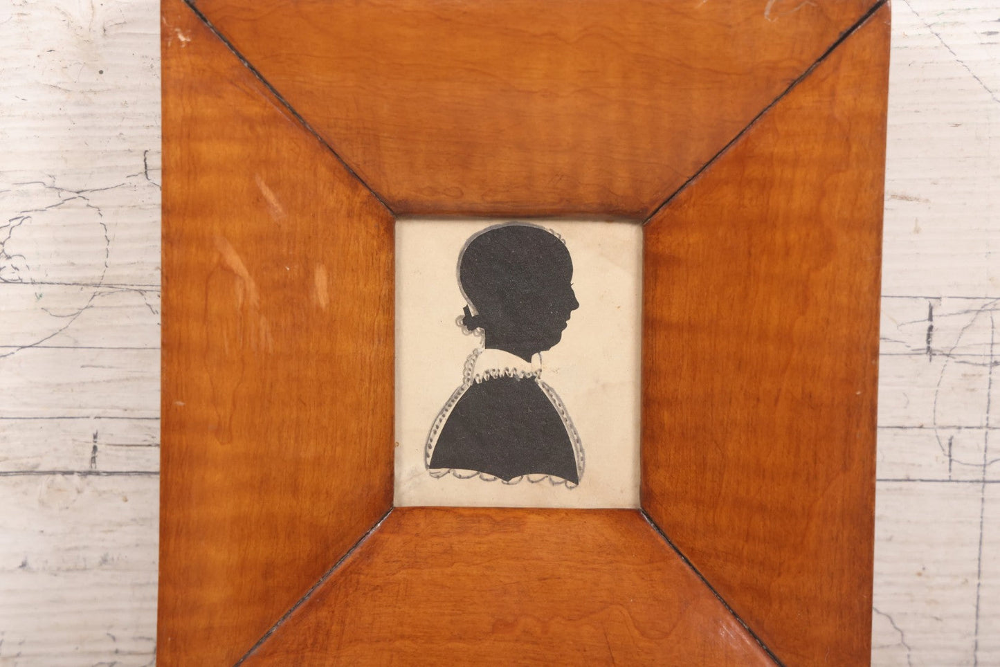 Lot 046 - Antique Folk Art Hand Cut Fabric Silhouette Of Young Girl With Added Pencil Details In Wide Tiger Maple Frame, 6-7/8" x 7-3/8"
