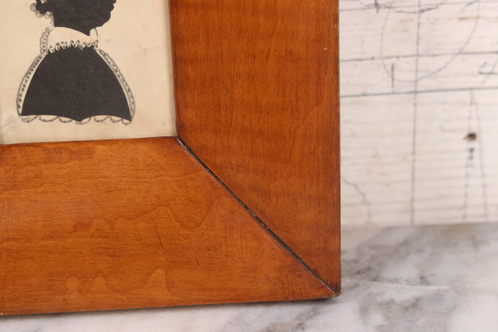 Lot 046 - Antique Folk Art Hand Cut Fabric Silhouette Of Young Girl With Added Pencil Details In Wide Tiger Maple Frame, 6-7/8" x 7-3/8"